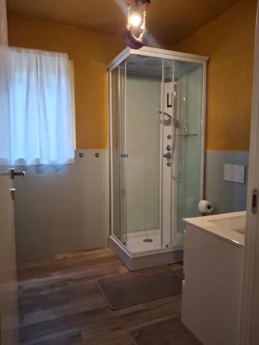 a bathroom with a shower with a glass door at Ca' della Civetta in Gavedo