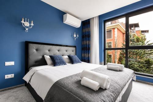 a blue bedroom with a large bed and a window at Top 10 3BR2BH Jacuzzi Free Parking in Sofia