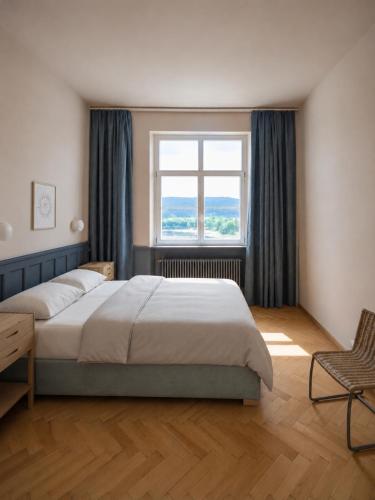 a bedroom with a large bed and a window at stuub schluchsee in Schluchsee