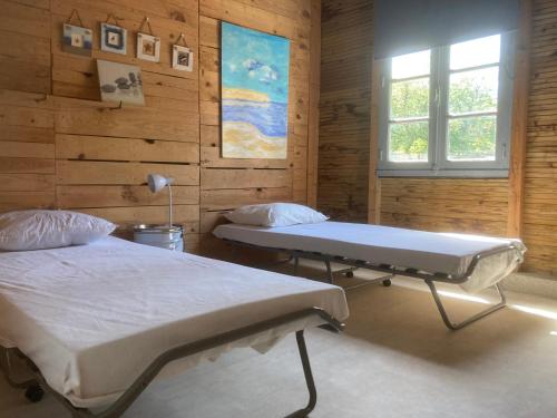 a hospital room with two beds and a window at Dortoir en charente in Jarnac