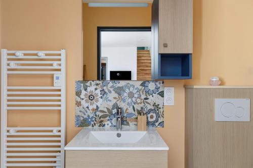 a bathroom with a sink and a mirror at chambre d'hôtes des bleuets in Saint-Firmin-des-Prés