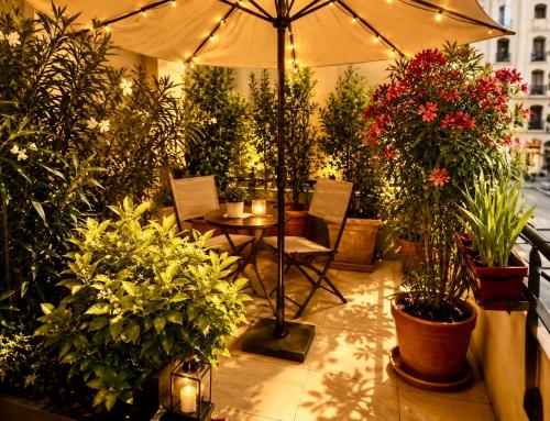 a patio with plants and a table with an umbrella at Le Aix Rotonde Mirabeau - Centre Ville Terrasse Garage in Aix-en-Provence