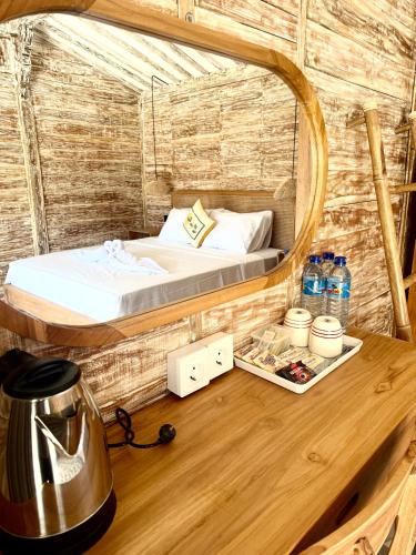 a bedroom with a bed in a round mirror at ADIBA village in Gili Meno