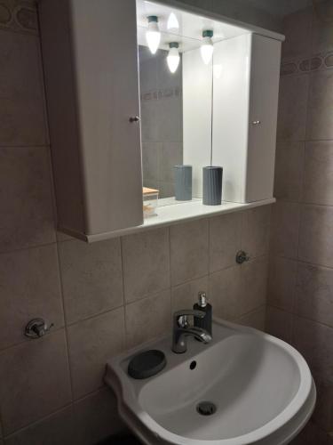 a bathroom with a sink and a mirror at Nana apartment in Perea