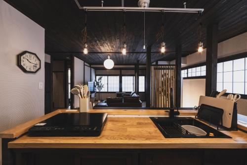 a kitchen with a counter top with a sink at Hidasumika Ojin AN in Takayama