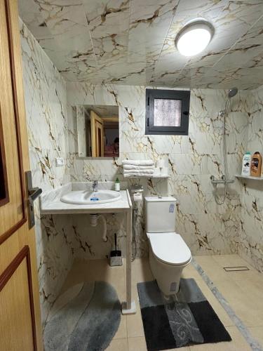 a bathroom with a toilet and a sink at DAR Assoul in Khenifra