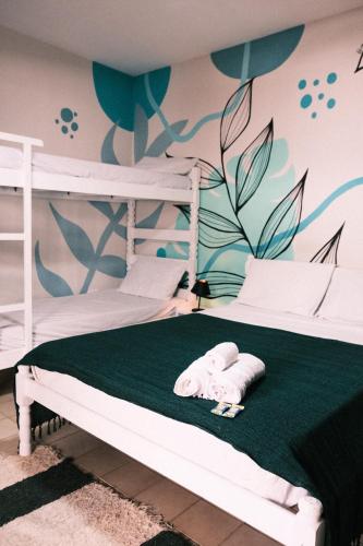 a bedroom with two bunk beds with a towel on the bed at Caiçara Guest House in Ubatuba