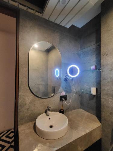 a bathroom with a sink and a mirror at Darshana Studios#Galaxyblue sapphire#Stylish in Ghaziabad