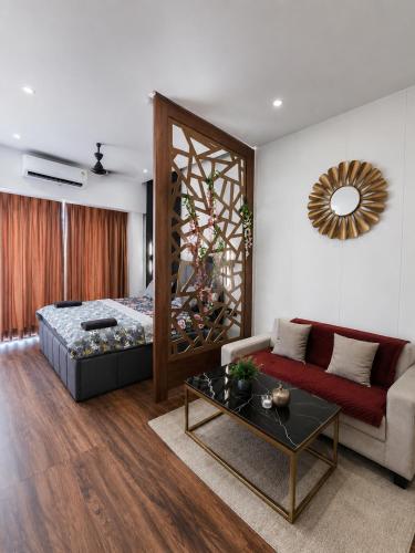 a living room with a bed and a couch at Darshana Studios#Galaxyblue sapphire#Stylish in Ghaziabad