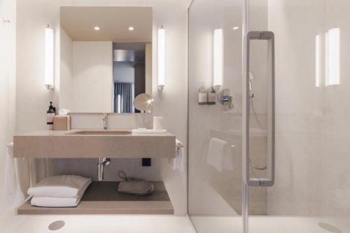 a bathroom with a sink and a shower at Hotel White Lisboa in Lisbon