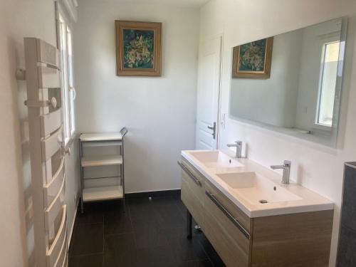 a bathroom with a sink and a mirror at Les Hauts de Bassens in Bassens