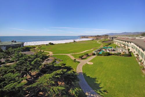a view of the beach from the balcony of a resort at Cavalier Oceanfront Resort in San Simeon