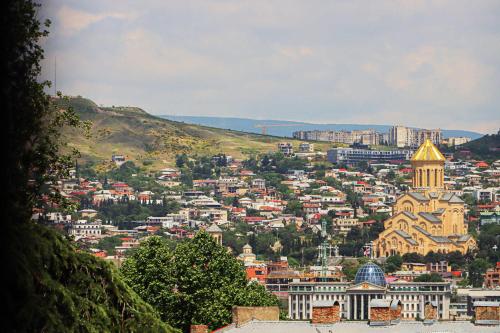 a view of a city with a mountain in the background at Spacious Sololaki 2BR with Balcony - by Wehost in Tbilisi City