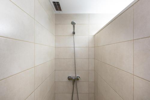 a shower with a shower head in a bathroom at Rentalmar Sol de España - Mas d'en Gran in Cambrils