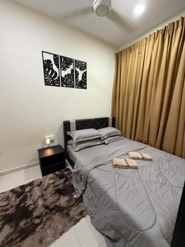a bedroom with a bed with two shoes on it at MiD Guest House in Gambang