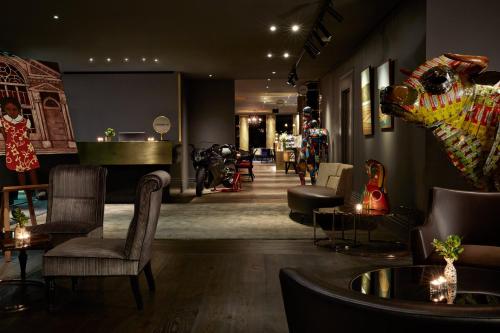 a store with chairs and tables and a piano at Museum Apartment Hotel, Independent Collection by EVT in Wellington