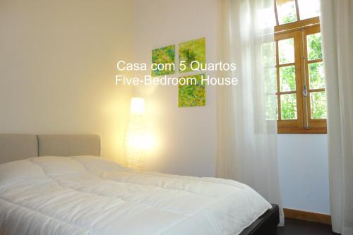 a bedroom with a white bed with a window at First Balcony - Porto Santo in Porto Santo