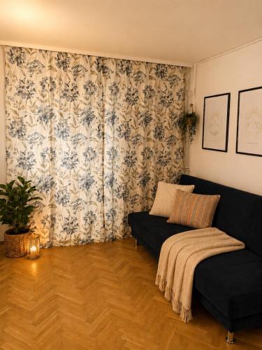 a living room with a bed and a couch at Studio Słowackiego in Września
