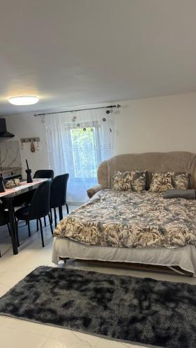 a bedroom with a bed and a table and chairs at Gemini house in Măcin