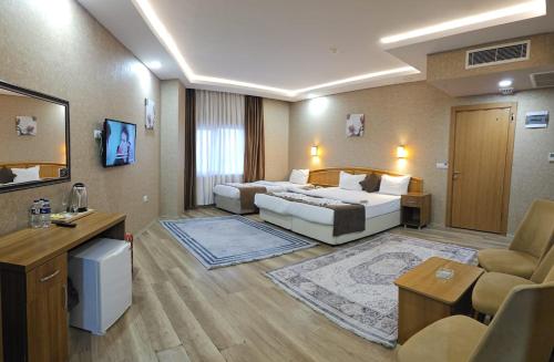 a hotel room with two beds and a couch at POINTBREAK OTEL in Degirmen