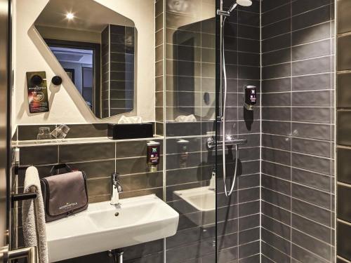 a bathroom with a sink and a shower at ibis Styles Pforzheim in Pforzheim