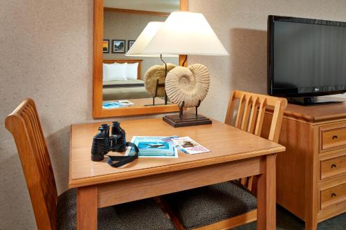 a room with a table with a television and a mirror at Cavalier Oceanfront Resort in San Simeon