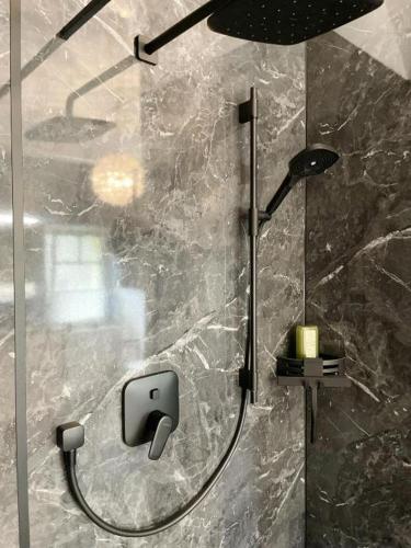a bathroom with a shower with a shower head at Villa Stolle, Ferienwohnung in Schneverdingen