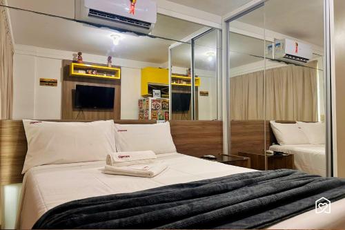 a bedroom with a bed with a large mirror at Mar Bello in Ilha da Restinga