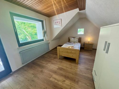 a attic room with a bed and a window at Ferienhaus zum Wasserfall in Bernkastel-Kues