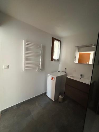 a small kitchen with a refrigerator and a sink at Appartement Villars Colmars in Villars-Colmars