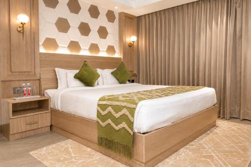 a bedroom with a large bed in a room at White Wharf Manesar in Gurgaon