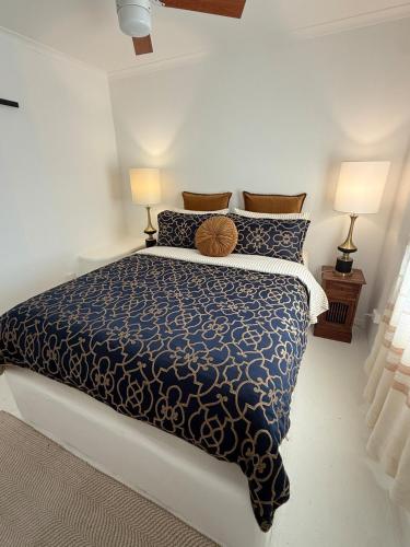 a bedroom with a large bed with two lamps at Little Mykonos right here in Stanthorpe! in Stanthorpe