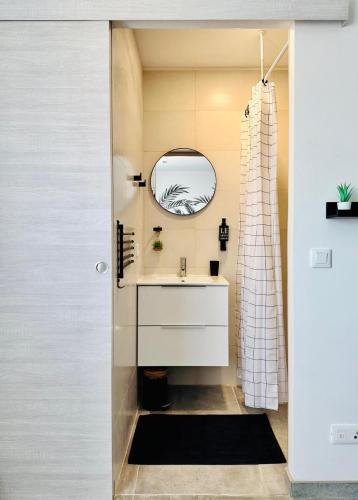 a bathroom with a sink and a mirror at La Kaz Eden * * * * in Les Cocos
