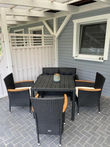 a wooden table and chairs on a patio at Ferienhaus Usedom in Kamminke