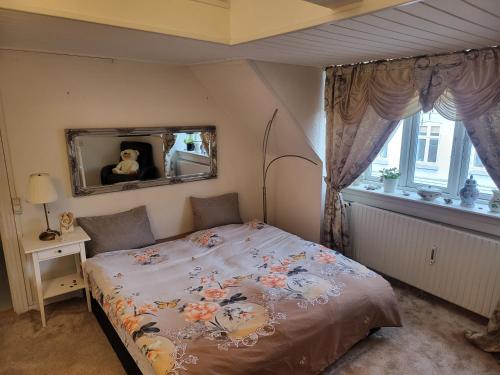 a bedroom with a bed and a mirror at Nice Apartment in Aalborg