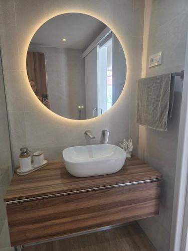 a bathroom with a sink and a mirror at Apartamento relax Tauro in Mogán