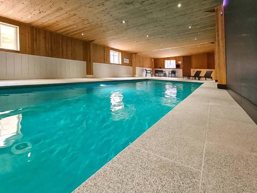 a swimming pool with blue water in a building at Ash Cottage - Ukc9266 in Hope