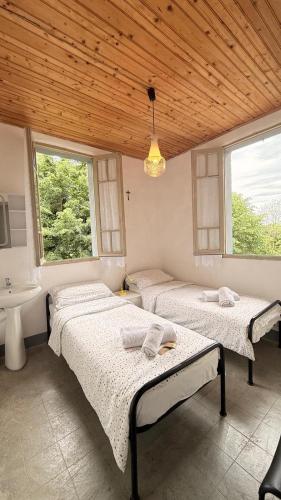 two beds in a room with a sink at Albergo Santa Maria in Esino Lario