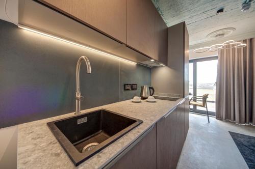 a kitchen with a sink and a counter at Loft 23 Boutique Hotel in St. Julianʼs