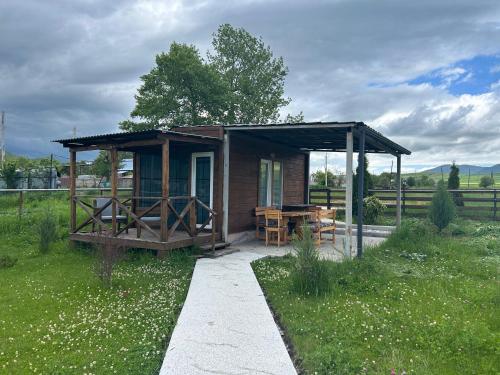 a small cabin with a picnic table in a field at V&V Hotel in Gyulagarak