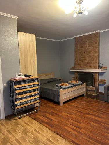 a room with a bed and a fireplace in it at Людмила in Chornomorsk