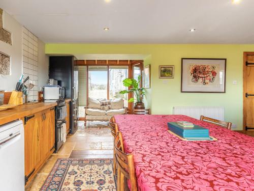 a kitchen with a table with a red table cloth at Seaton Court - Uk31955 in Staithes