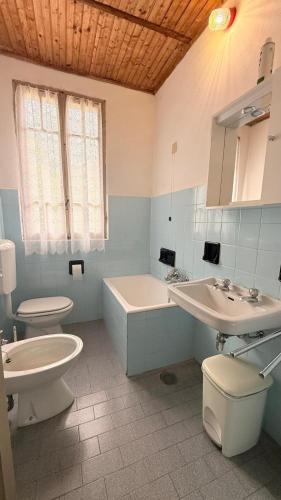 a bathroom with two sinks and a tub and a toilet at Albergo Santa Maria in Esino Lario