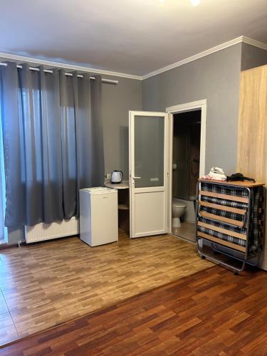 an empty room with a room with a toilet and a table at Людмила in Chornomorsk