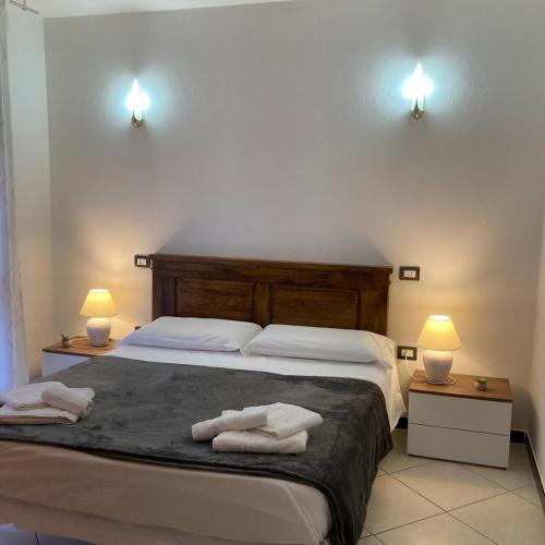 a bedroom with a large bed with towels on it at Casa Vacanza Margherita in Assemini