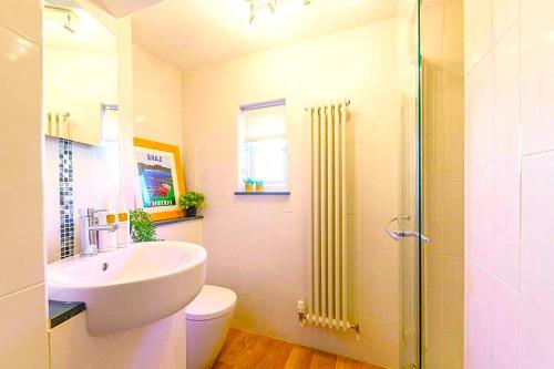 a bathroom with a sink and a toilet and a shower at Premium Hotel EXO-Near Temple and Ghat#Parking and Comfort Stay#Premium Service in Varanasi