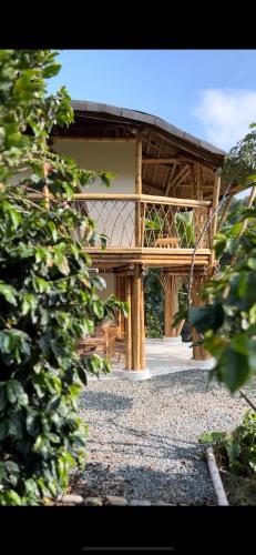 a wooden building with a bench in front of it at Moonshine - Sereno Glamping in Manizales