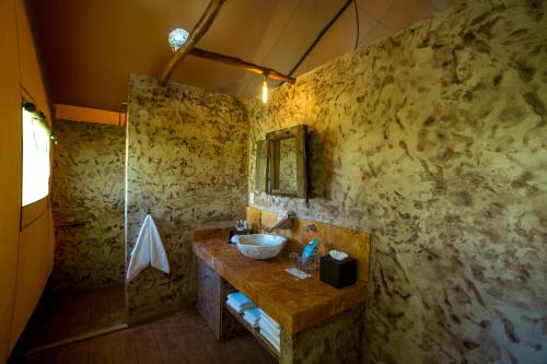 a bathroom with a sink and a shower at Serenity Authentic Glamping Tulum in Xpu Ha