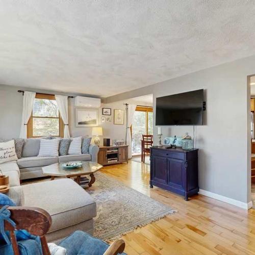 a living room with a couch and a table at Bay Pointe Bungalow in East Falmouth