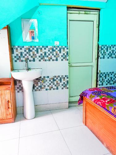 a bathroom with a sink and a bed at Hotel NAR NARAYANA in Chutwāpīpal